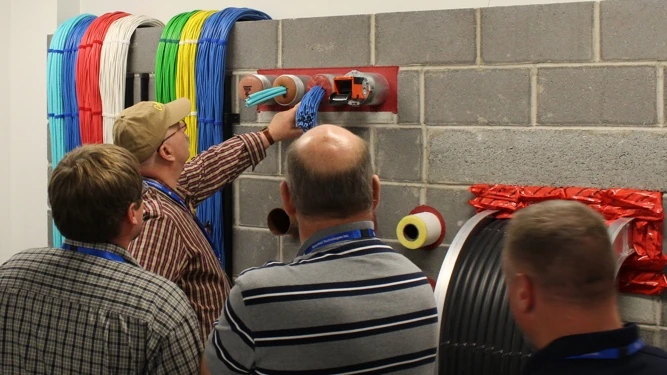 A training showing the correct way to apply firestopping materials